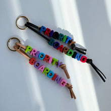 Load image into Gallery viewer, ‘PRIORITY BOARDING’ CHUNKY LEATHER BEADED BAG CHARM BY BOOM BESPOKE

